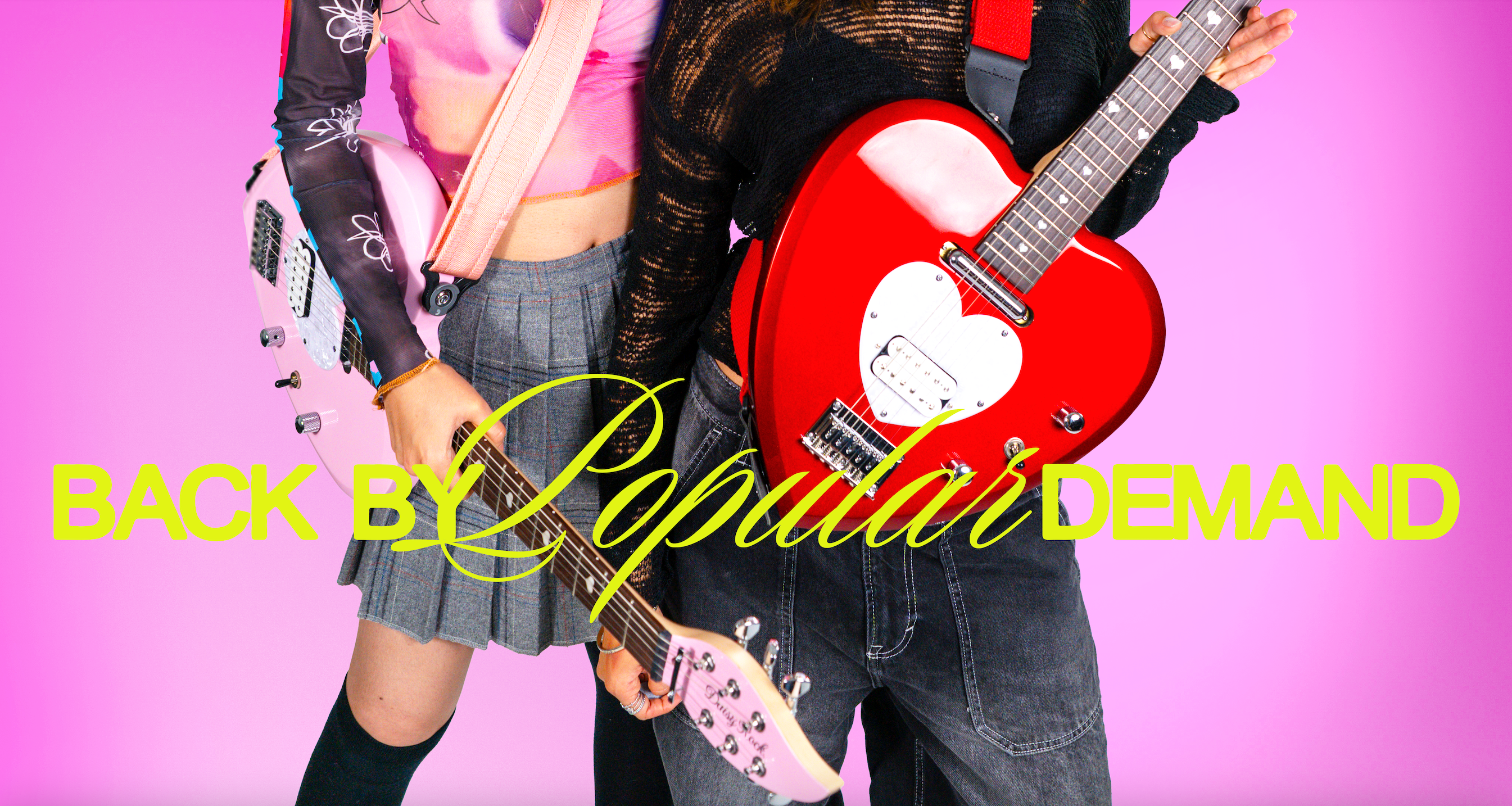 Two female models holding pink and red heart-shaped guitars against a pink backdrop with the phrase "Back by Popular Demand"