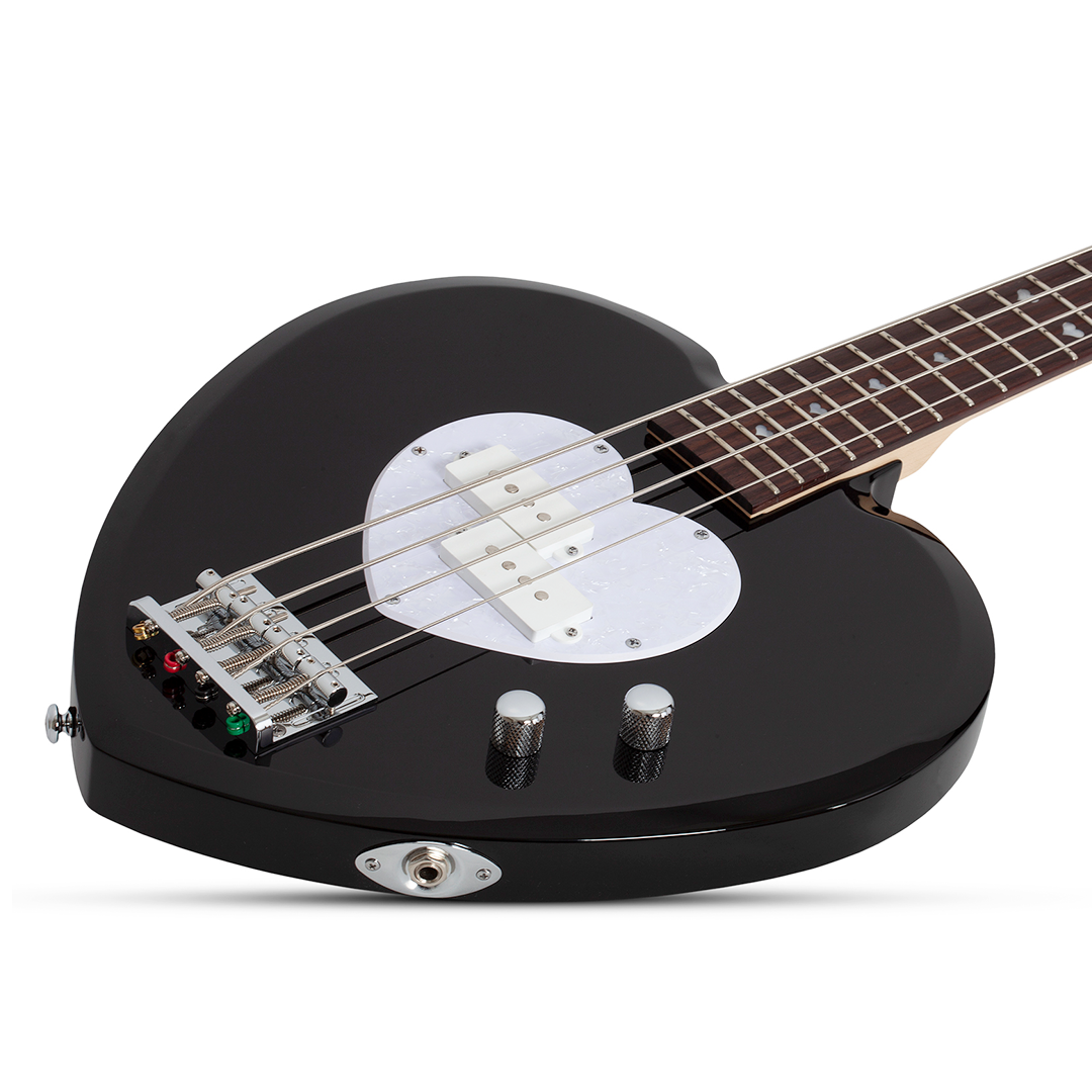 Black electric bass guitar with a heart-shaped body and white pick guard on a white background