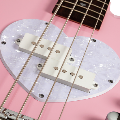 Close-up of a pink electric bass guitar bridge and strings with a white pearlescent pick guard