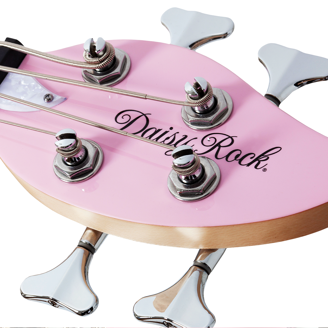 Close-up of a pink electric bass guitar leaf-shaped headstock with 'Daisy Rock' branding on a white background